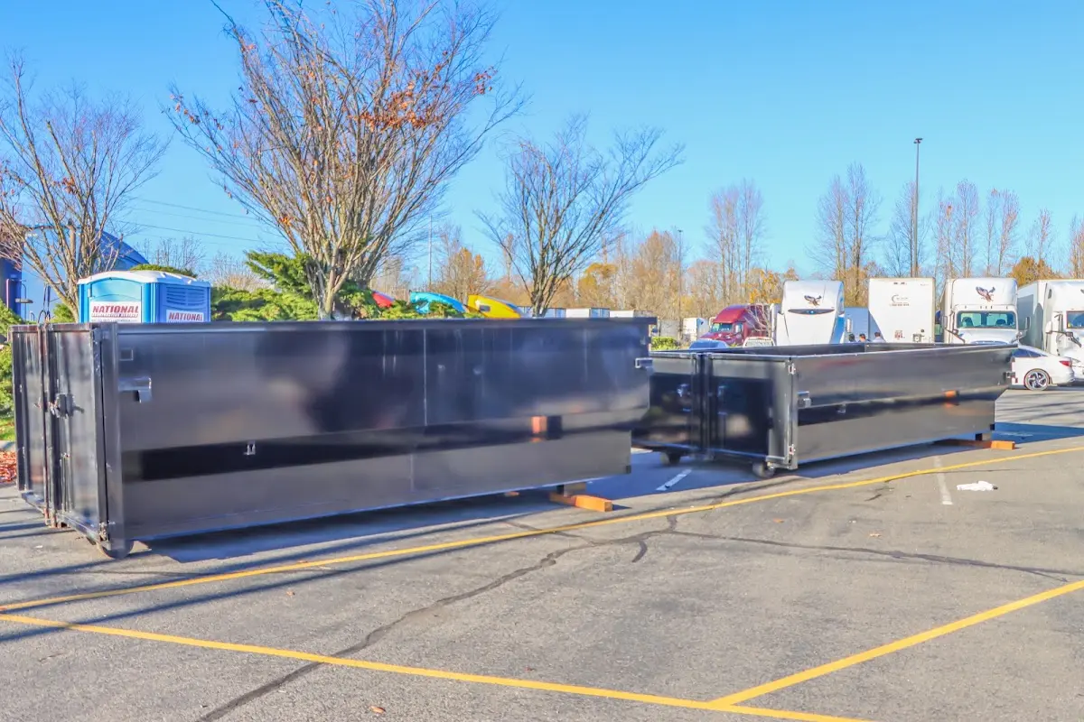 Professional dumpster rental service with roll-off container on residential driveway in Delray Beach